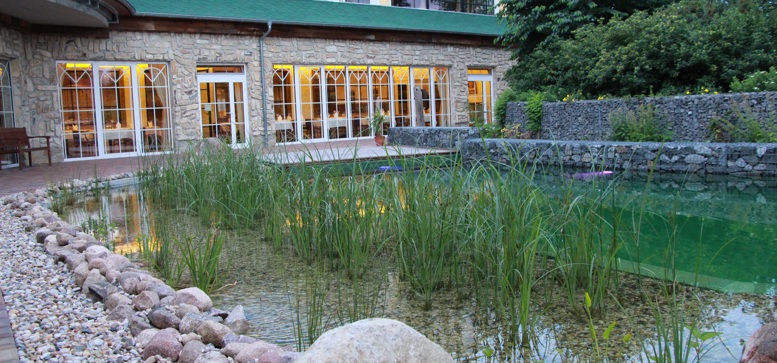 Wellness hotel SPA & nature resort “Seeschlösschen” in Senftenberg with Balena swimming pond, in the background the restaurant