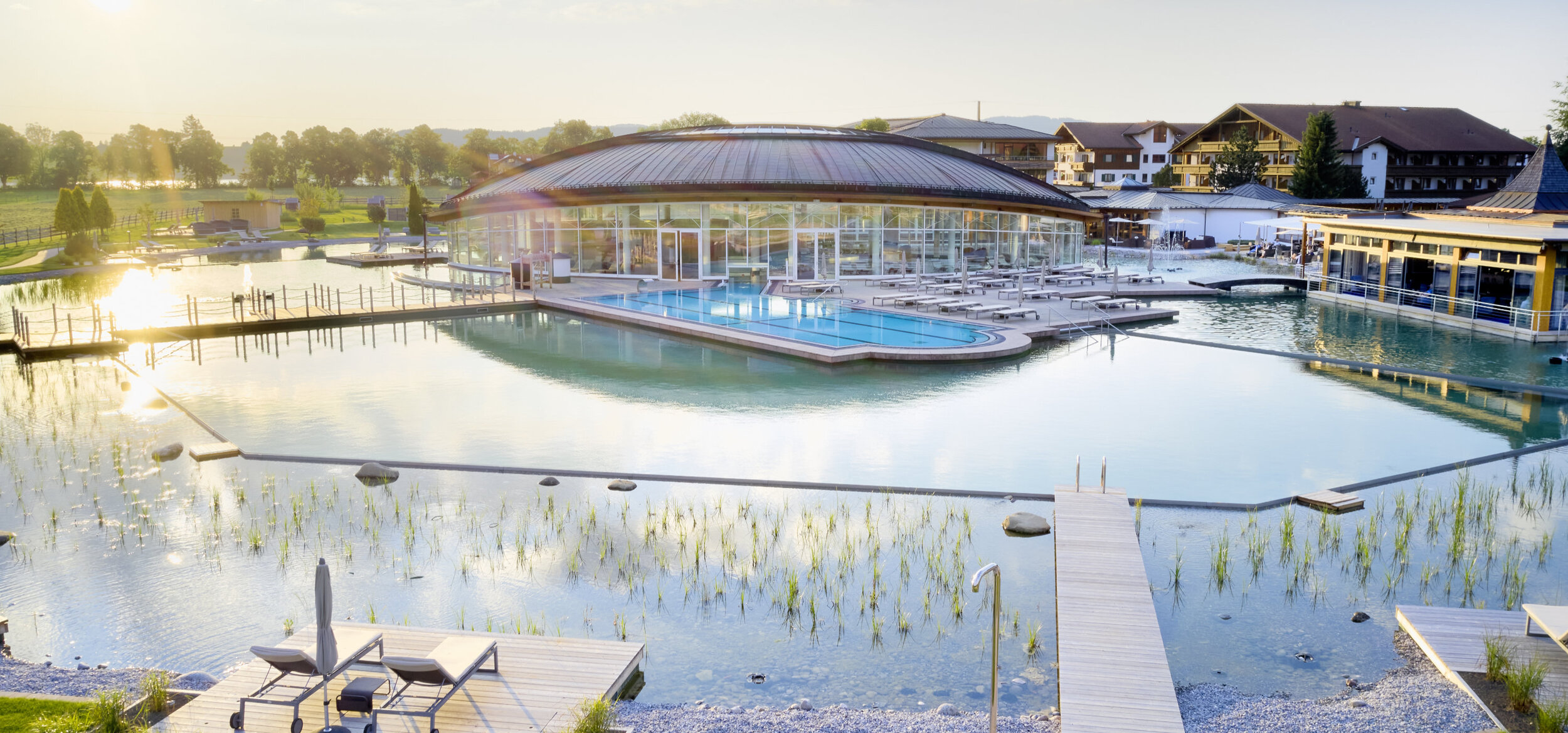 The pool area with Balena system at the “König Ludwig” Wellness & SPA Resort with loungers and plants